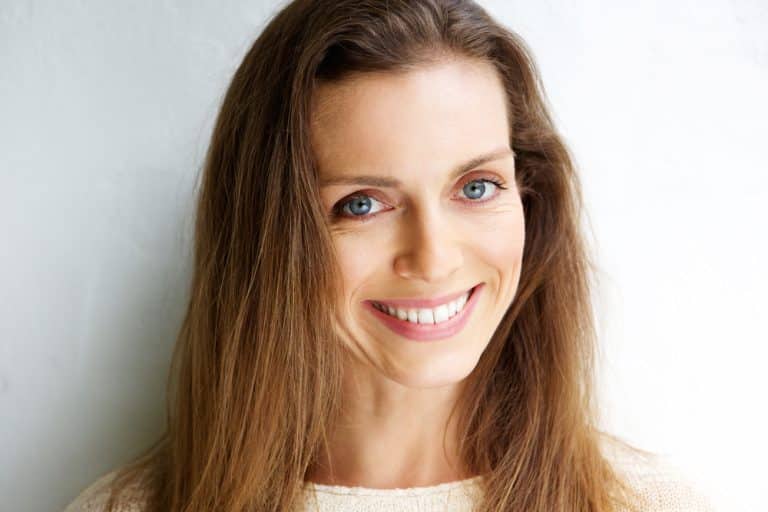 Woman smiles after full mouth restoration